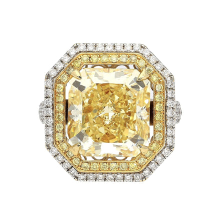 Gold and diamond ring with a large yellow gemstone on a white background