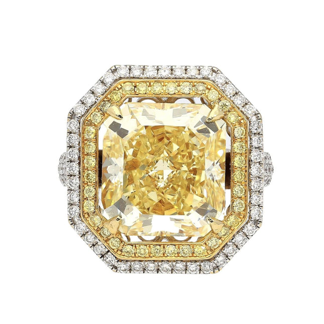 Gold and diamond ring with a large yellow gemstone on a white background